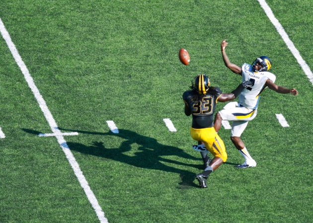 Defensive lineman Markus Golden (33) intercepts the ball from Toledo quarterback Terrance Owens (2). Golden ran the ball back for a touchdown but was penalized for unsportsmanlike conduct while celebrating.